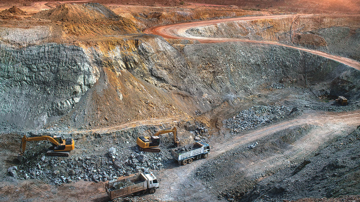 View of an open-cast gold mine with heavy machinery
