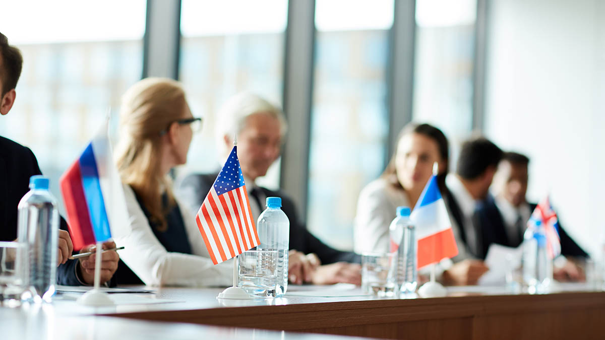 National flags on a conference table during diplomatic talks