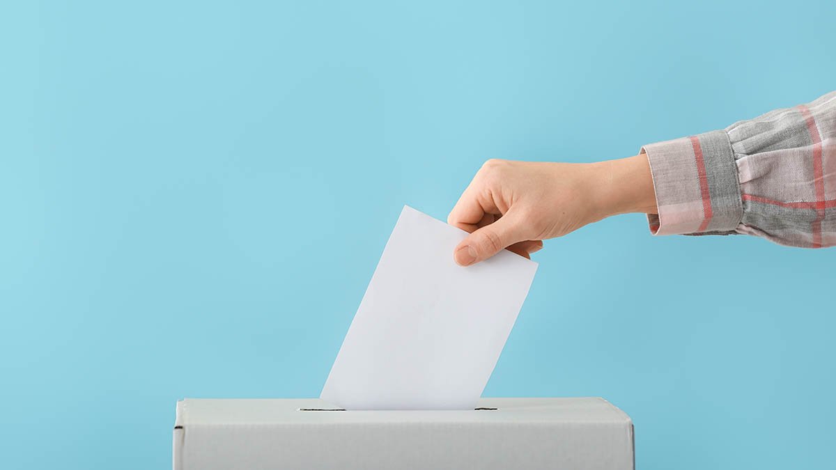 A voter casting a vote at a ballot box