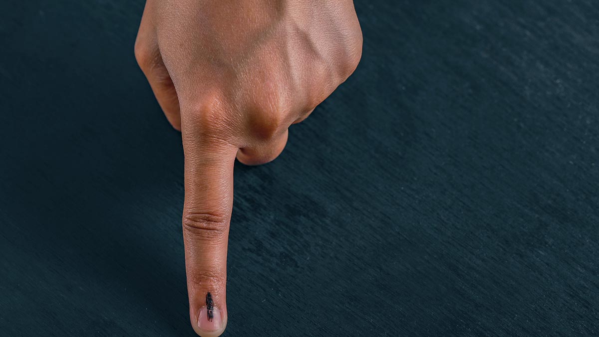 Indian voter showing inked finger after casting vote in an election