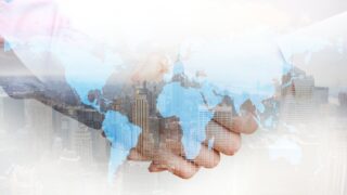 Business handshake against a city skyline