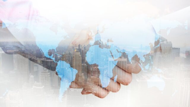 Business handshake against a city skyline
