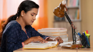 A young aspirant studying for a state government recruitment examination