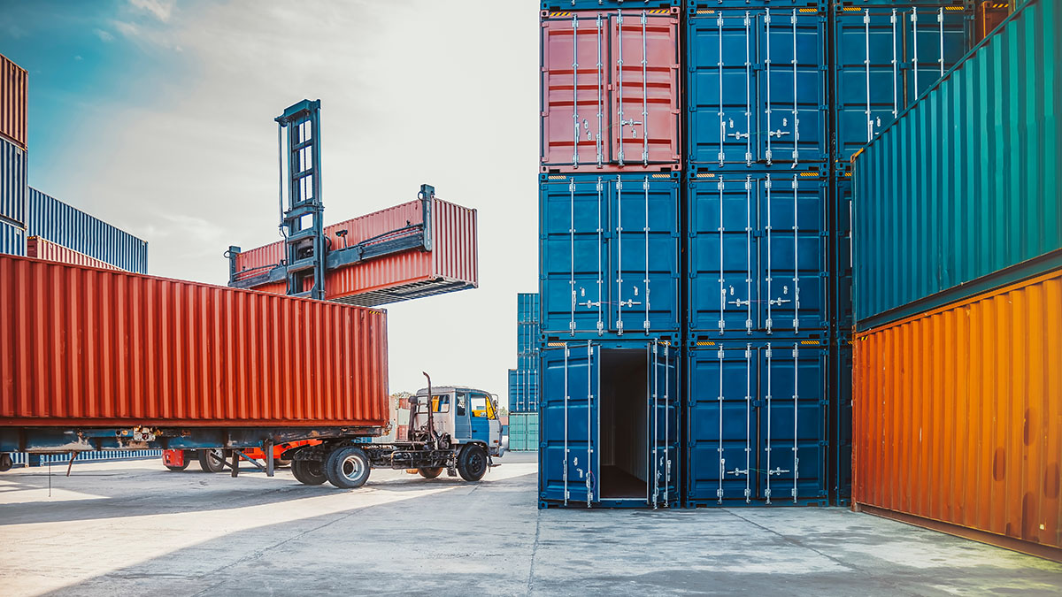Shipping containers being handled at a freight terminal